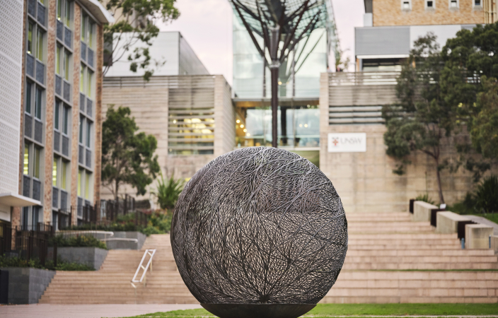 Sculpture of large metal Bronwyn Oliver Globe on the UNSW Library Lawn