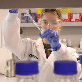 Photo of Savannah O’Connell working in her lab