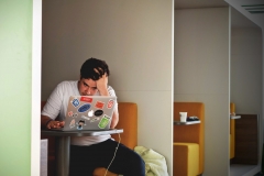 Man looking stressed while focused on a laptop 