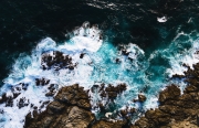 Aerial view of waves crashing on the rocks