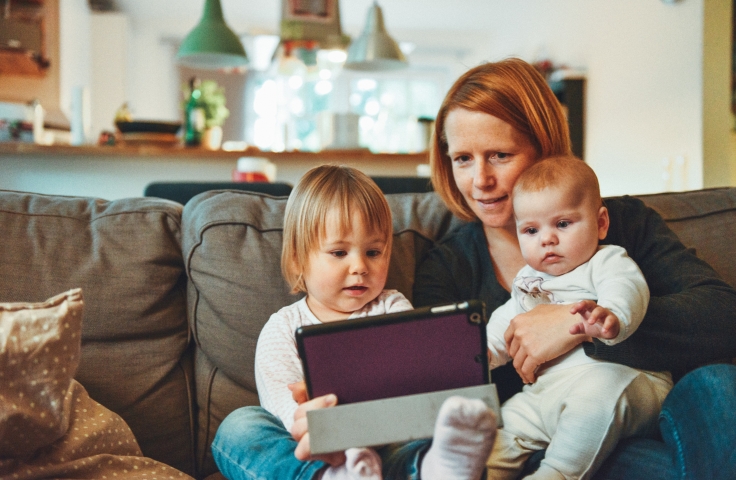 Mother with 2 children on a tablet at home