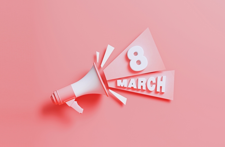 Light pink image of a megaphone with the words 8 March coming out 